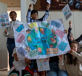 Kids holding a banner about the earth