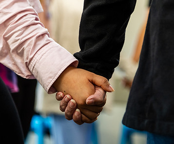 Two persons holding hands
