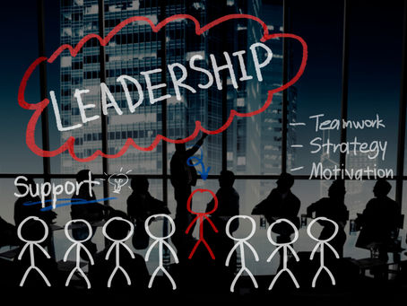 A conceptual business image illustrating leadership. In a modern office overlooking a city at night, a silhouetted leader presents to a team. The word "LEADERSHIP" is highlighted in a large, hand-drawn red cloud. Surrounding text includes "Teamwork," "Strategy," and "Motivation." Below, a row of stick figures represents the team, with the central leader figure colored red.