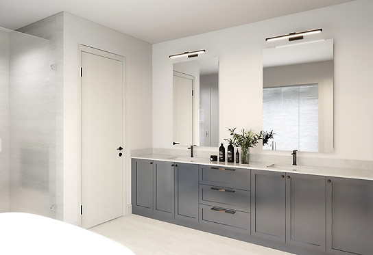Toronto custom home design build project by Nestwood Home, Powered by Z Squier Group. The image depicts a modern bathroom with a large white bathtub, a double sink vanity, and a large mirror above the sink. The vanity has two sinks, and there is a bottle of shampoo and conditioner on the counter. The walls are white, and the floor is made of gray tiles.