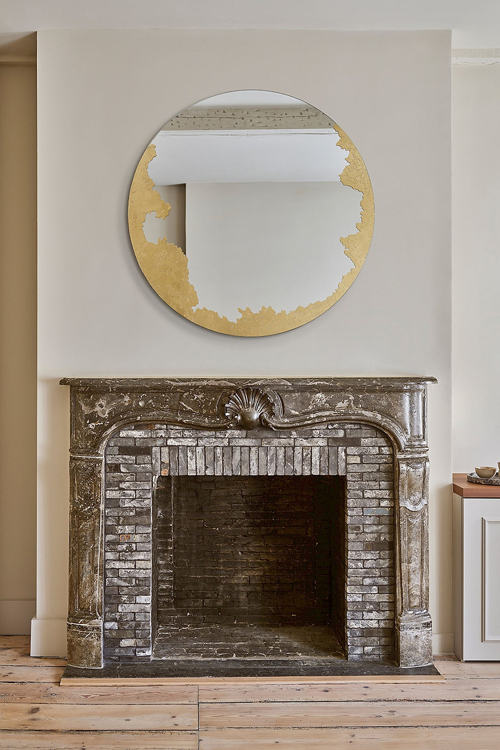 ornato round mirror on fire place