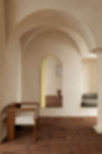 Thumbnail: Arched interior with wooden chair and illuminated niche