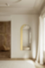 Thumbnail: Arched mirror with gold detail in a bright, modern room