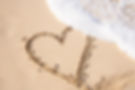 heart drawing in sand on beach