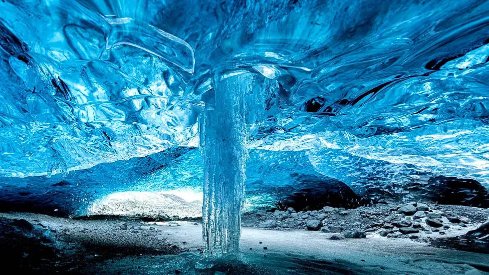 Inside an ice cave in Iceland, showcasing vibrant blue ice formations and a central ice column
