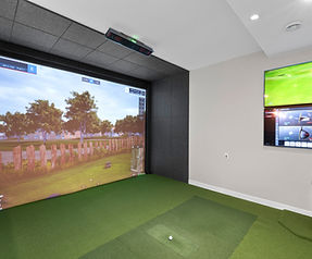 Basement golf simulator with full-swing hitting area and impact screen, Muskego, WI