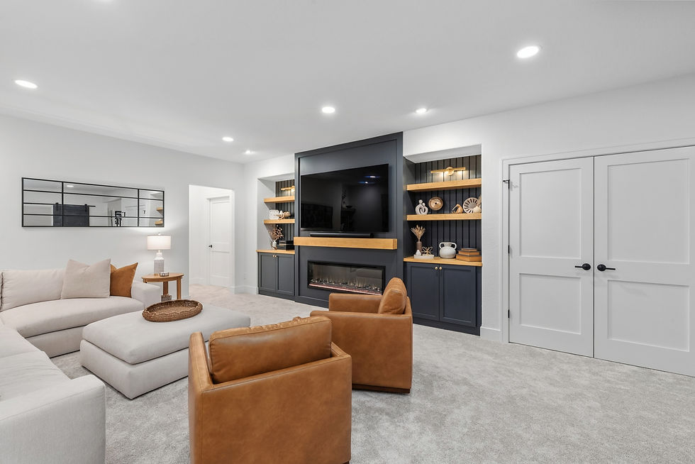 Open lower level living area with sectional, custom fireplace wall and maple built-ins, Town of Lisbon, WI