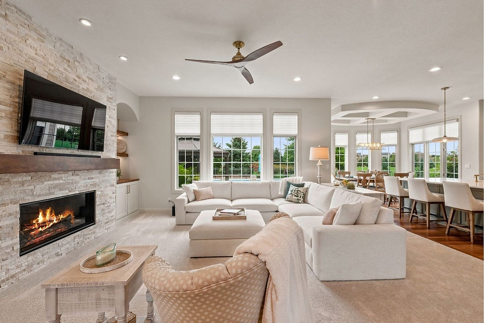 Open main level connecting the family room's stacked-stone fireplace to the kitchen and breakfast area, Hartland, WI