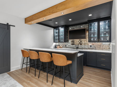 Lower level wet bar with Iron Ore cabinetry, maple beam and leather bar stools, Town of Lisbon, WI
