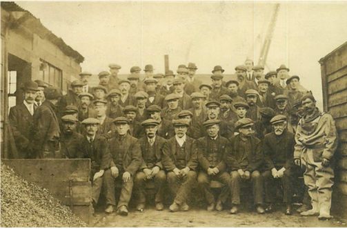 A group of industrial workers wearing hats in Glasgow