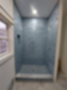 Modern bathroom remodeling with blue tiled walk-in shower