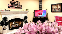 Beige Room with white Fire Place and Yomary's Studio Sign Above, Studio Monitor, Artwork.