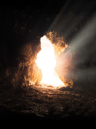 light bursting through an opening of a cave, point of view from inside the cave