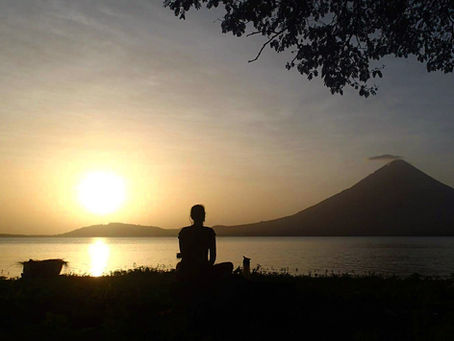 woman looking at sunset vulcano isla ometepe
