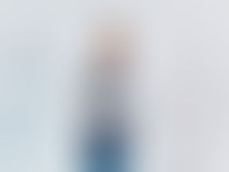 Man posing in front of white backdrop