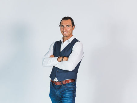 Man posing in front of white backdrop