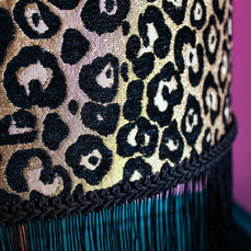 Leopard Print Lampshade with black fringe.