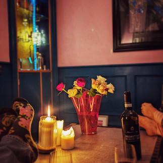 A table scene with flowers and wine 