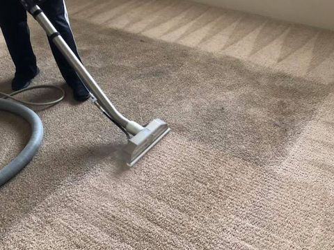 Steam cleaning wand extracting dirt from beige carpet runner