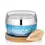 Thumbnail: Passport to Organics Blue Water Hyaluronic Moisturizer in a 1.7 oz jar with a vibrant blue color and silver lid, displayed on its included round wooden stand with a wooden leaf-shaped tag engraved with 'Passport.