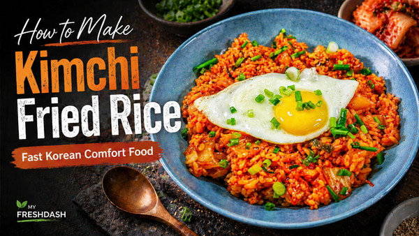 Recipe thumbnail showing a blue bowl of bright orange kimchi fried rice topped with a sunny-side-up egg and green onions, with bold text reading “How to Make Kimchi Fried Rice” and “Fast Korean Comfort Food.”