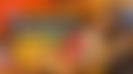 Commercial thumbnail for “Best K-Drama Snacks: Korean Snacks to Eat While Watching Shows,” featuring a cozy living-room scene with a woman wearing headphones and eating chips while watching a drama, surrounded by popular Korean snack packs, bowls of snacks, a drink, and bold headline text.
