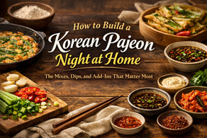 Premium blog thumbnail for a Korean pajeon night at home, featuring golden scallion pancakes, dipping sauces, chopsticks, and elegant dinner-table styling with bold title text.