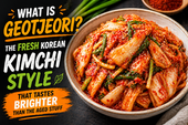 Fresh geotjeori kimchi served in a ceramic bowl with crisp napa cabbage coated in bright red seasoning, scallions, and sesame seeds, alongside bold thumbnail text reading “What Is Geotjeori?”