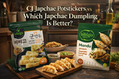 Comparison thumbnail in a warm kitchen setting featuring CJ Japchae Potstickers and Bibigo Japchae Wang Gyoza packages with plated fried dumplings, japchae noodles, and bold headline text.