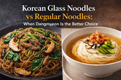 Blog thumbnail comparing Korean glass noodles and regular noodles, with glossy japchae-style dangmyeon topped with beef, mushrooms, spinach, and sesame on the left, and pale noodles in broth with kimchi, mushrooms, and cucumber on the right, under the headline “Korean Glass Noodles vs Regular Noodles: When Dangmyeon Is the Better Choice.”