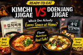 Promotional comparison graphic for ready-to-eat Korean stews. Large text reads “Kimchi Jjigae vs Doenjang Jjigae” and “Which One Actually Earns Space at Home?” The left side shows a kimchi stew package and a steaming bowl of red, spicy-looking stew labeled “Bold, Spicy, Comfort.” The right side shows a doenjang stew package and a steaming bowl of brown soybean paste stew labeled “Savory, Deep, Balanced.” Center text highlights “Flavor, Nutrition, Real Talk!”