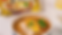Bowl of Shin Ramyun Gold with chicken, broccoli, corn, green onion, and the package blurred in the background.