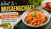 MyFreshDash thumbnail showing musaengchae, a crisp Korean radish banchan, served in a ceramic bowl with red-orange seasoning, green onions, and sesame seeds beside bold text explaining the dish.