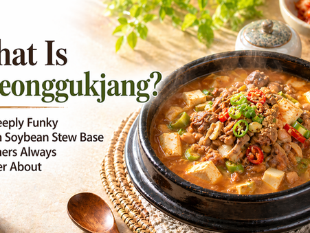 Bright morning-style blog thumbnail with a steaming black stone bowl of cheonggukjang stew filled with tofu, beef, soybeans, and red and green chili slices on the right, and large headline text on the left reading, “What Is Cheonggukjang? The Deeply Funky Korean Soybean Stew Base Beginners Always Wonder About.”