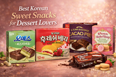 Best Korean sweet snacks display featuring pistachio chocolate cake, Orion Fresh Berry cake, cacao pie, choco pie, and strawberry cream crackers on a warm dessert-themed background