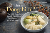 Premium MyFreshDash thumbnail showing dongchimi in a white ceramic bowl with crisp Korean radish, greens, and clear chilled broth beside traditional jars and elegant title text.