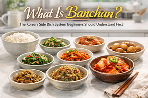 Korean banchan side dishes and white rice arranged on a bright modern kitchen counter, with the title “What Is Banchan?” above.