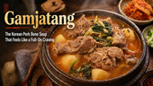 Steaming bowl of gamjatang, a Korean pork bone soup with tender pork, potatoes, and greens in a rustic earthenware pot, with kimchi in the background and the headline “Gamjatang: The Korean Pork Bone Soup That Feels Like a Full-On Craving.”