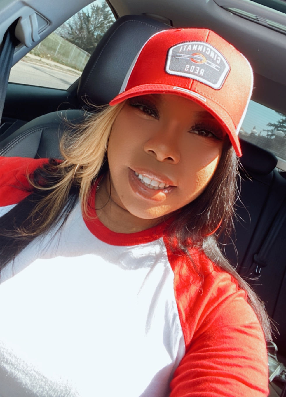 Nequa wearing Cincinnati Reds apparel and a red Reds hat before heading downtown for Cincinnati Reds Opening Day 2026 festivities.