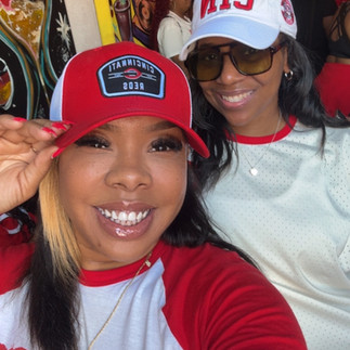 Nequa and bestfriend smiling inside a downtown Cincinnati venue during Cincinnati Reds Opening Day 2026 celebrations wearing Cincinnati Reds gear.