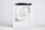 Thumbnail: White Ollie and Ginger Whiskey Ember gift box tied with navy grosgrain ribbon box, scented candles, and essential oils.