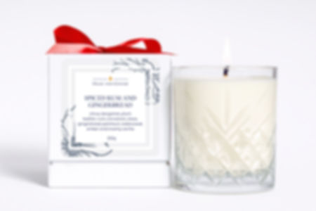 Spiced Rum and Gingerbread candles gift box with text and a lit candle.