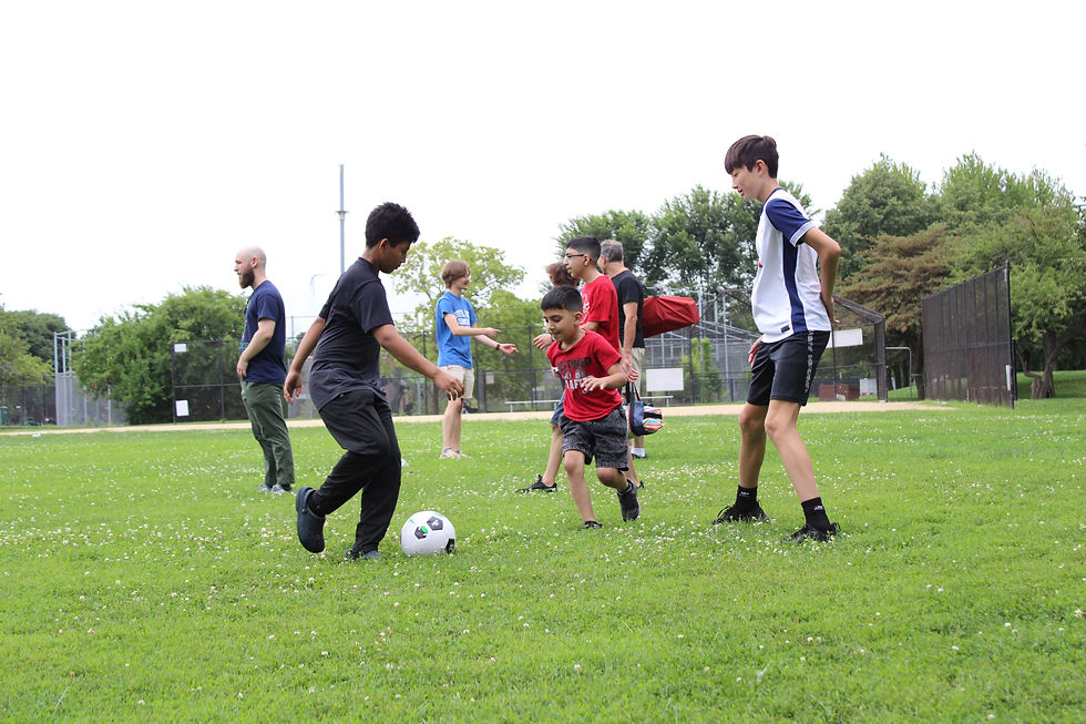 FORA students and community playing soccer at our 2025 community picnic