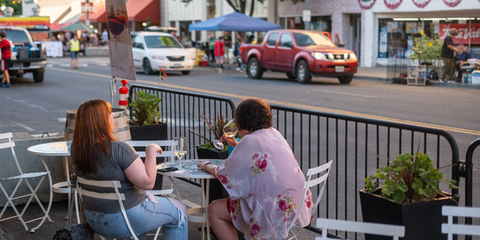 Two friends eating outside Pendleton downtown