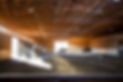 people riding horses in indoor arena