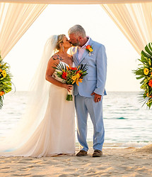Bride & Groom Kissing with Sail boat in the Background
