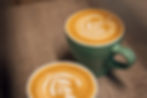 flat white coffee with latte art in a green cup