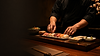 Chef preparing fresh sushi at Kamon Sushi
