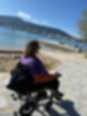 [Image Description: A picture of Erin Founder of Claiming Disability on the beach in Athens Greece[