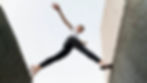 bottom-view-woman-parkouring-buildings.jpg